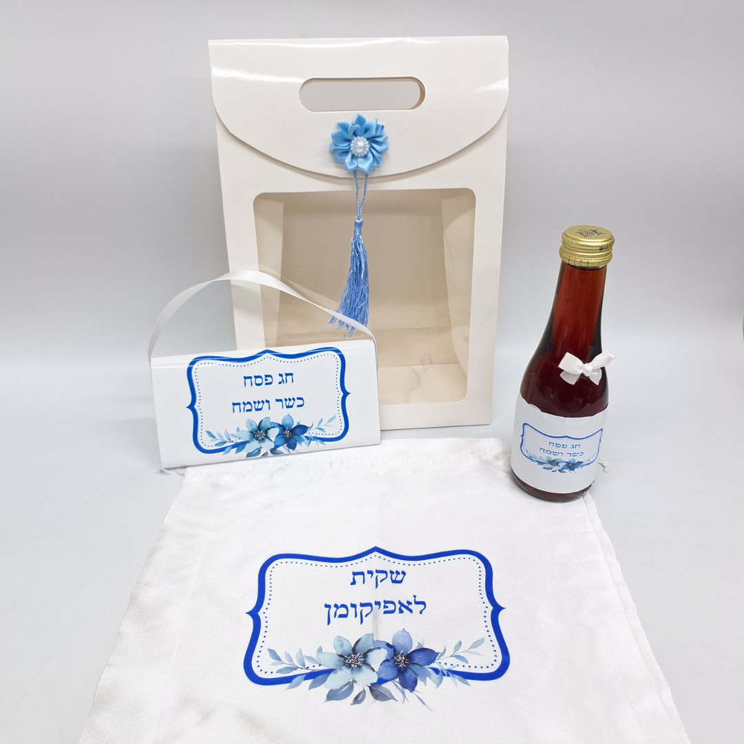 קופסת מתנה לבנה עם בקבוק יין אדום ותווית כחולה לפסח